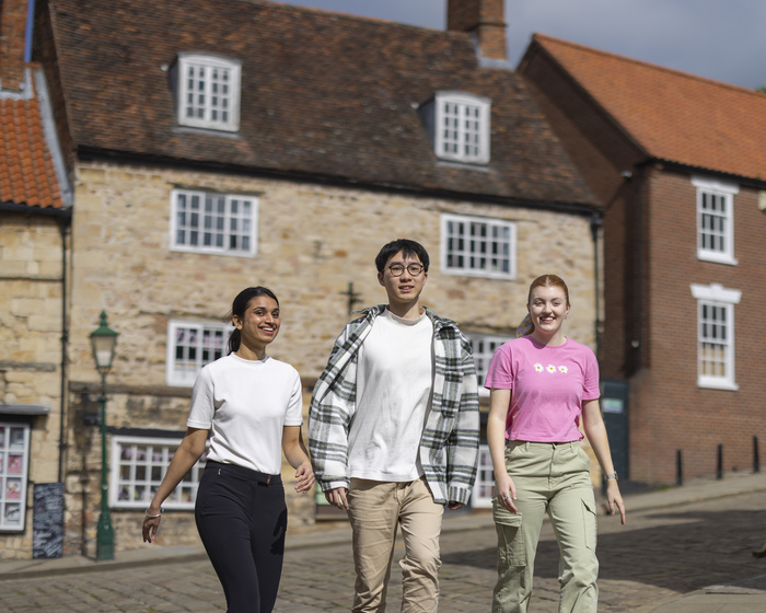 Three students walking through Lincoln
