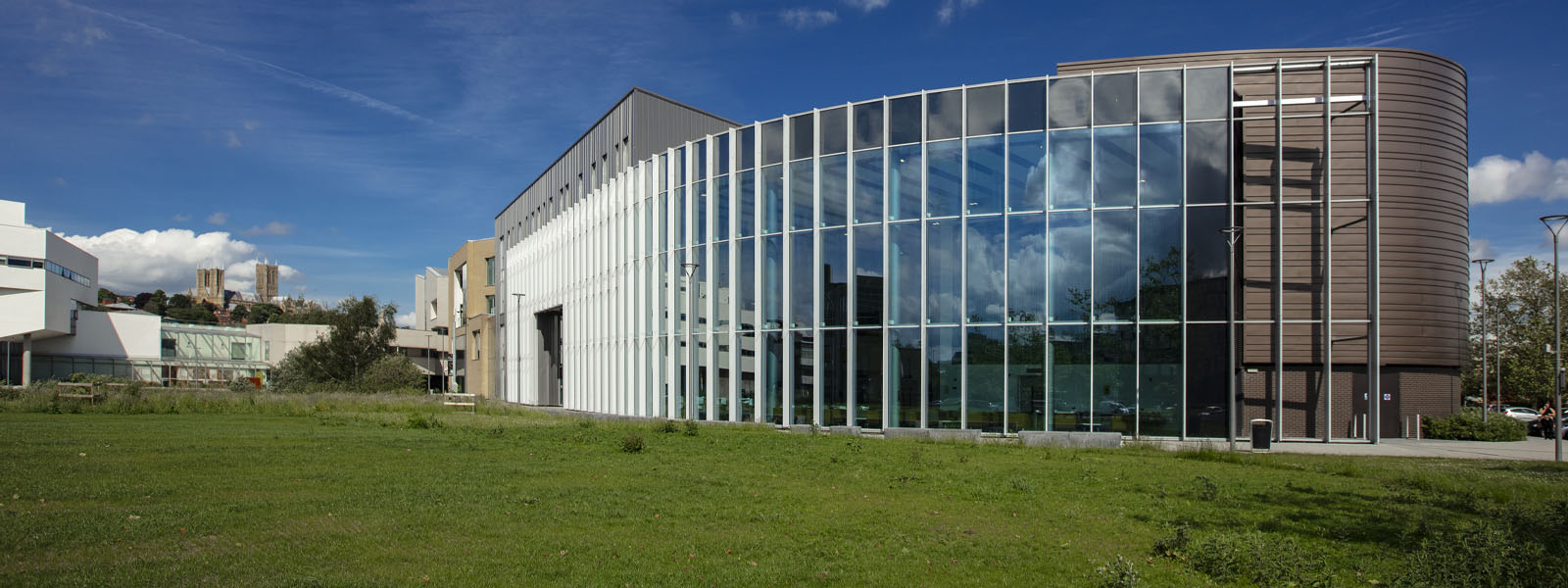 Exterior shot of the Isaac Newton Building and glass frontage