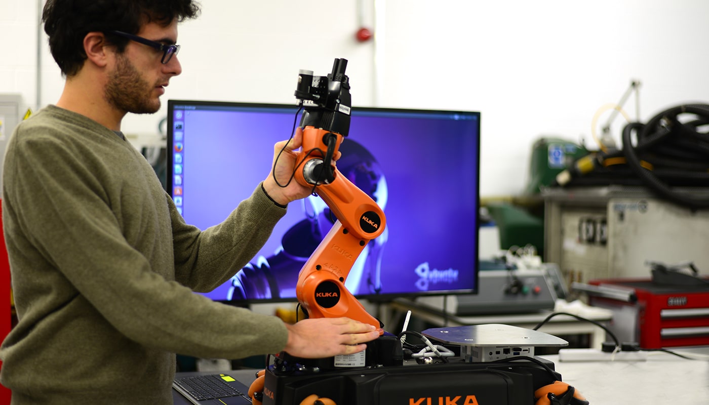 Man working with an engineering robot in a lab