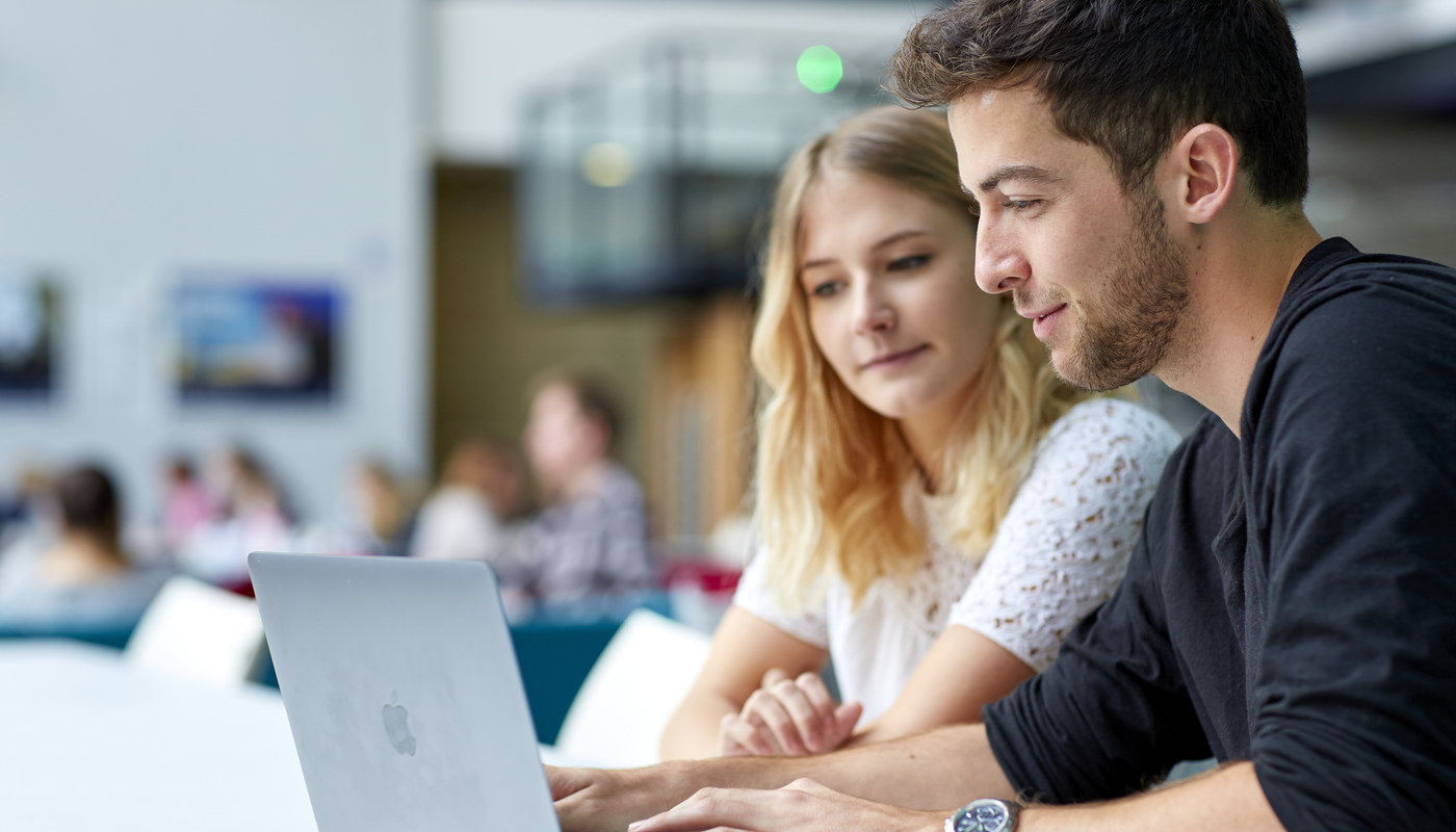 Two students using a laptop