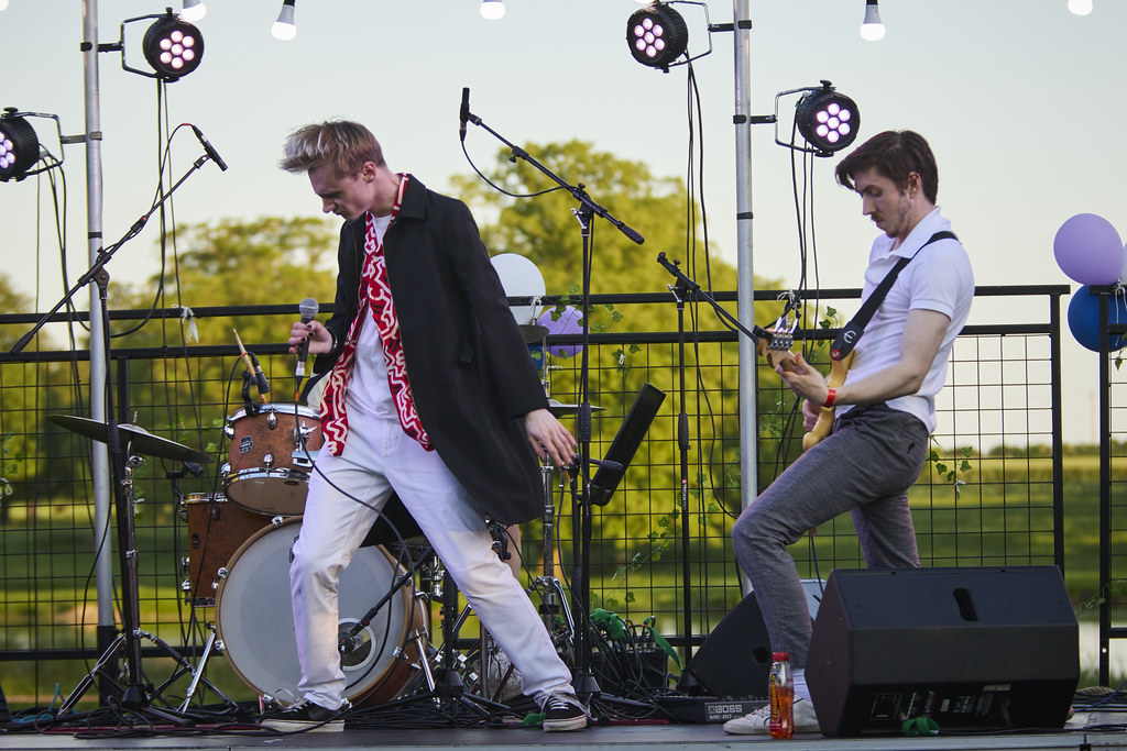 Students singing and guitaring on stage