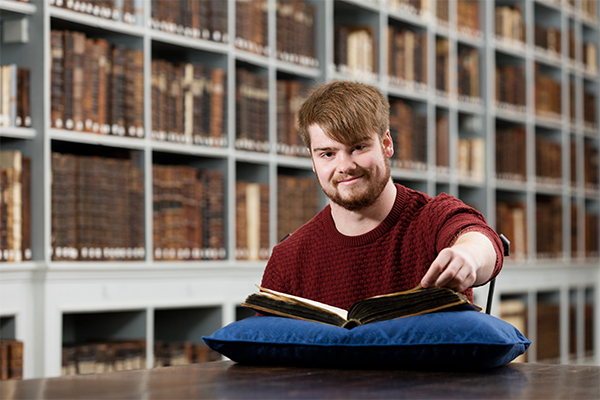 A student sat reading an old book