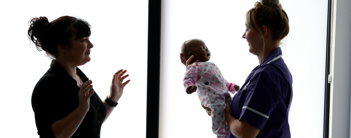 Student midwife in a mock hospital environment