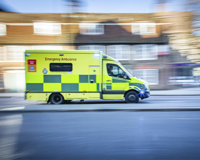 An ambulance speeding along a city road