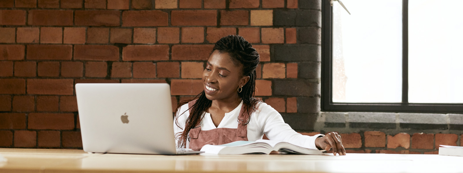 Female student working at a laptop in the library