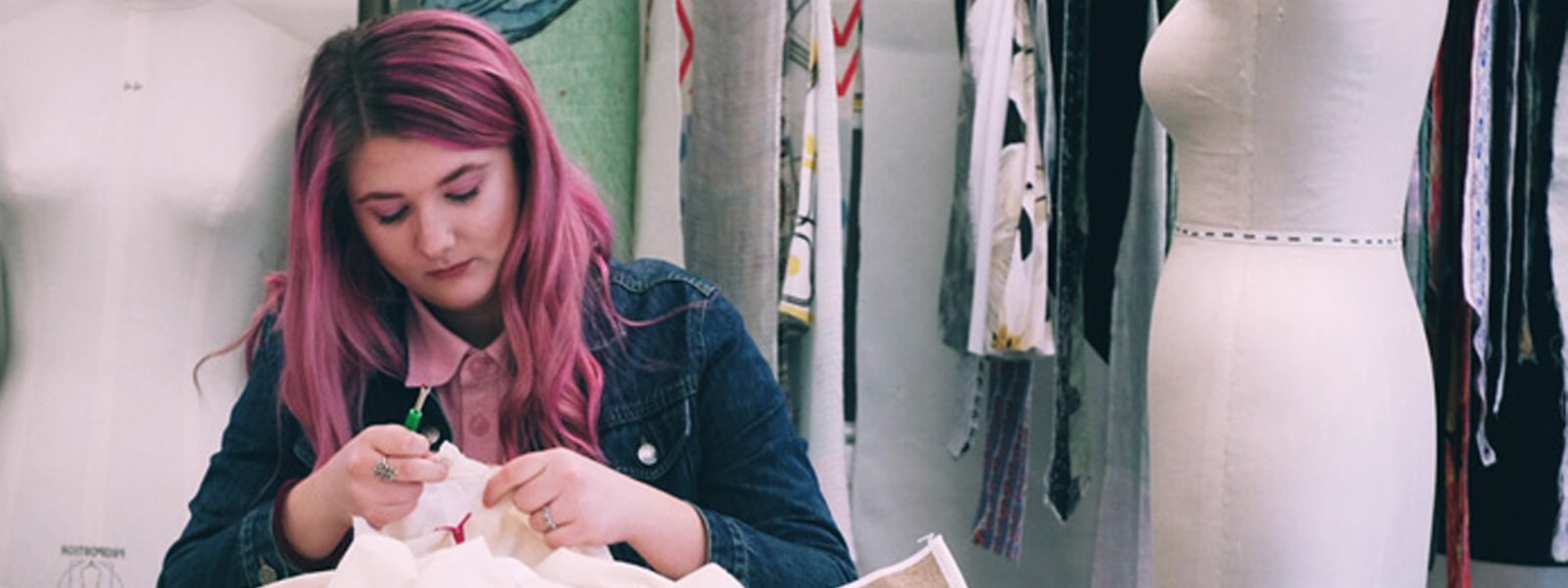 Female fashion student working on a garment in the fashion studio