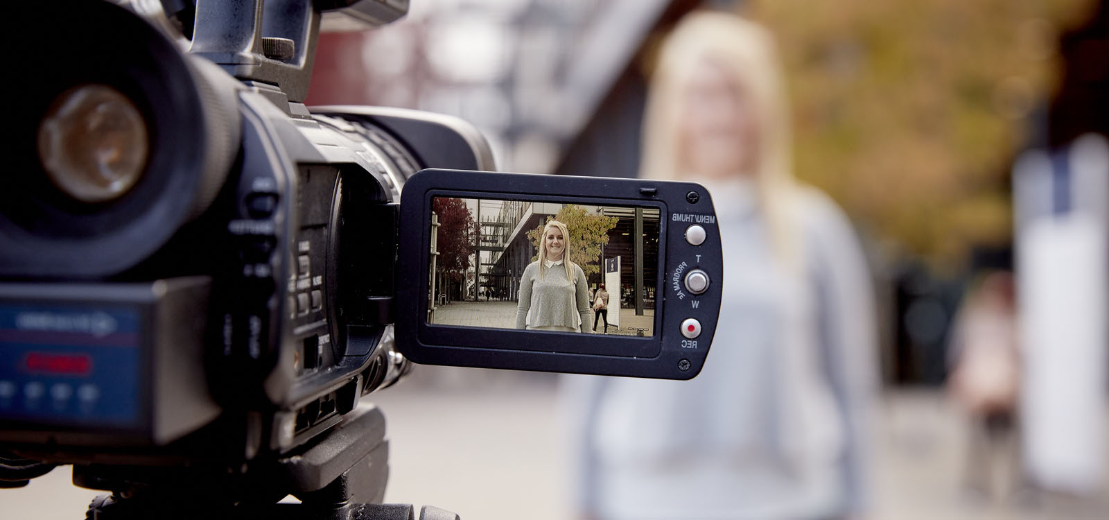 Close up of a video camera being used by students 