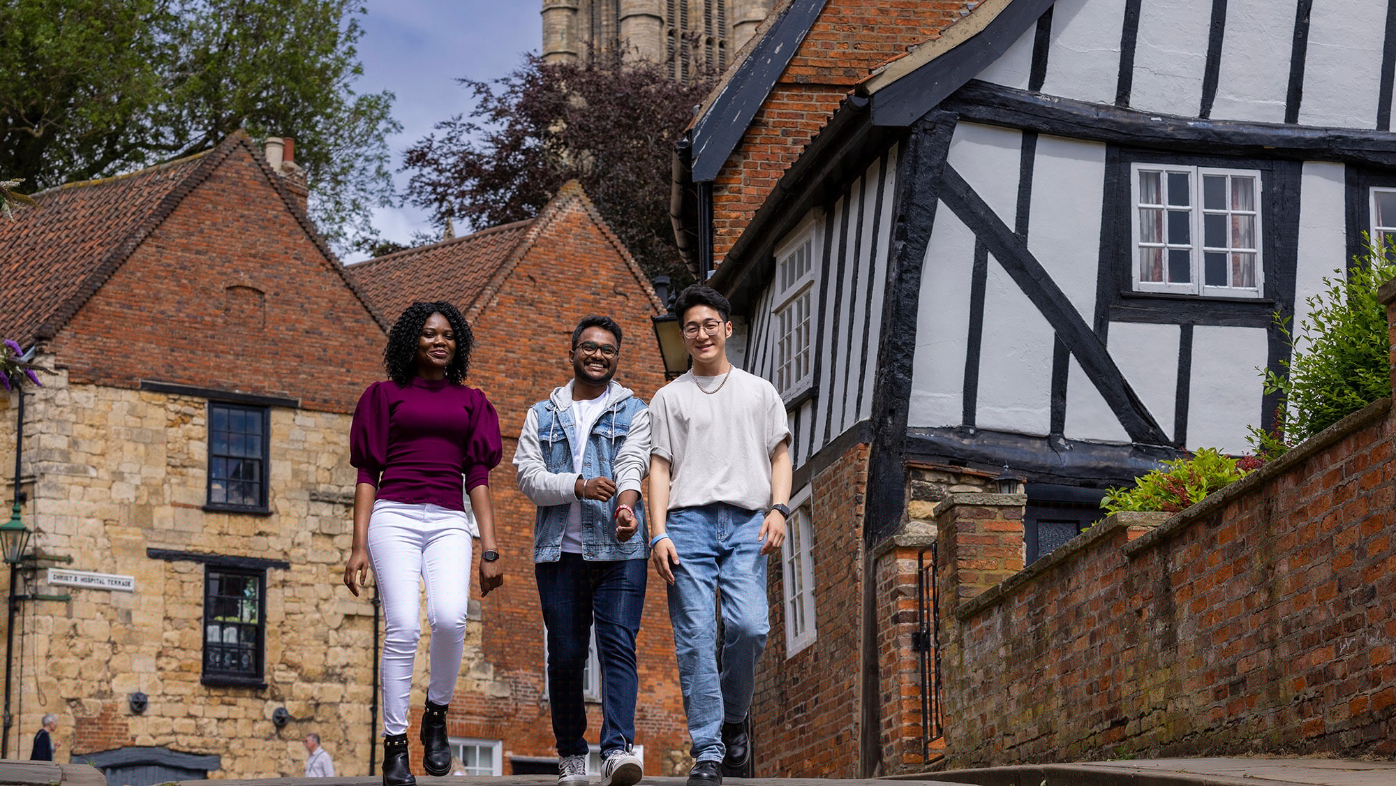 3 students walking uphill Lincoln