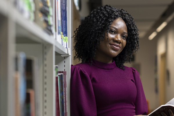 Student in library smiling