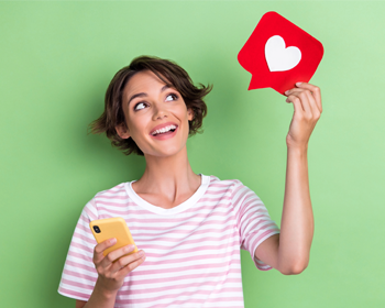 Woman holding up heart emoji sign