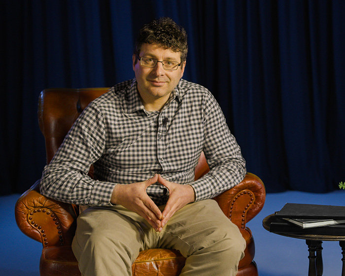 Charles Fox sat in an armchair smiling