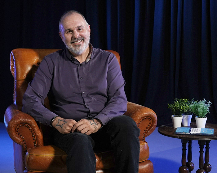 A man sat in a brown armchair