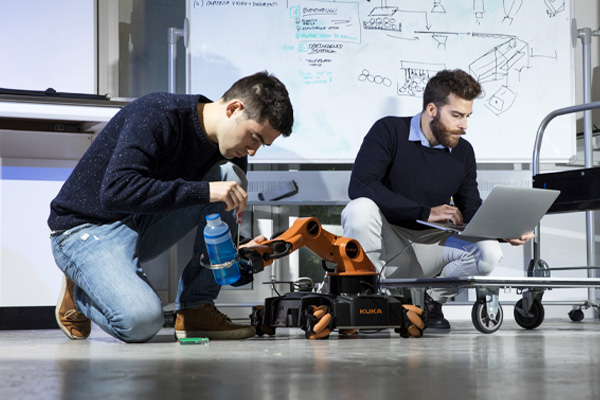 Two students working in an engineering lab