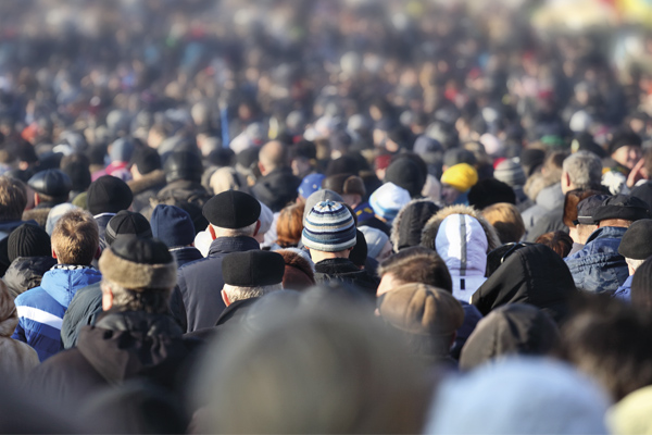 A crowd of people walking down a street
