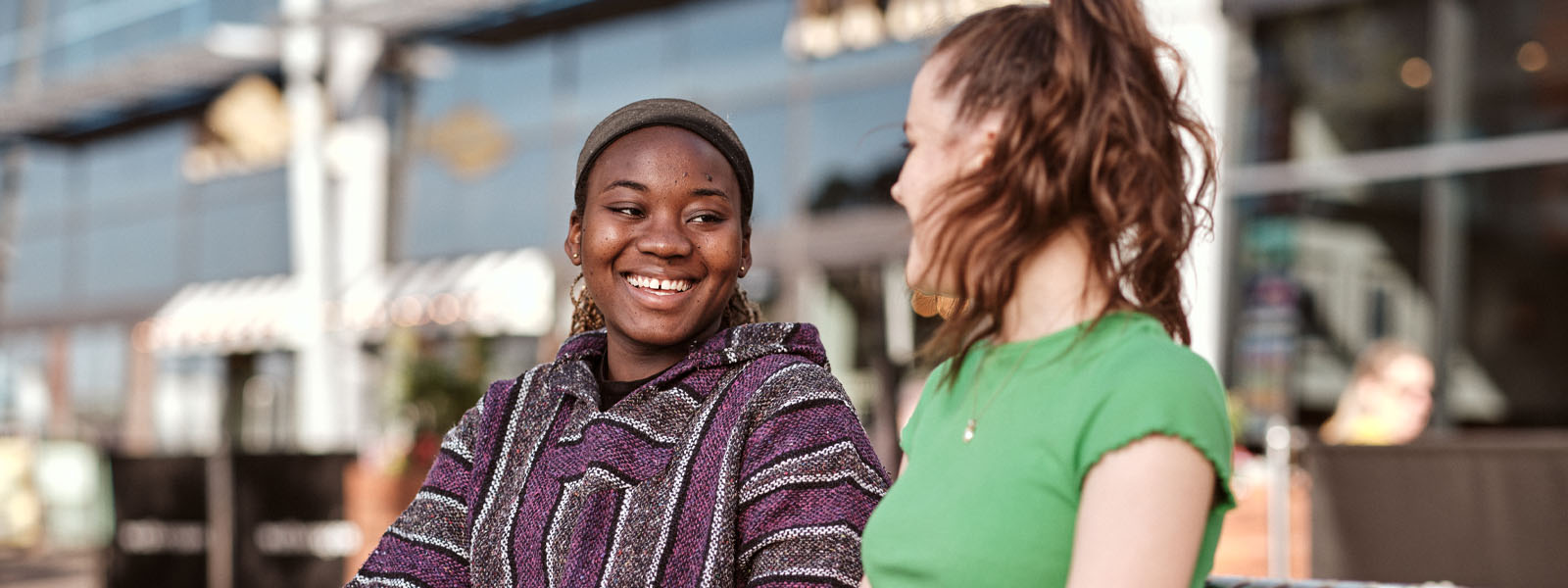 Two students sat taking on the Brayford Waterfront