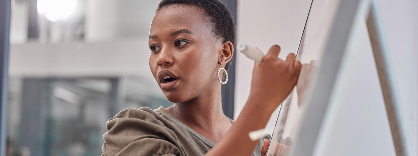 Young professional manager delivering a talk using a whiteboard