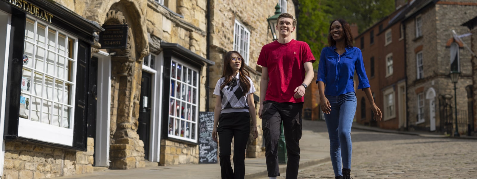 Three students walk down steep hill