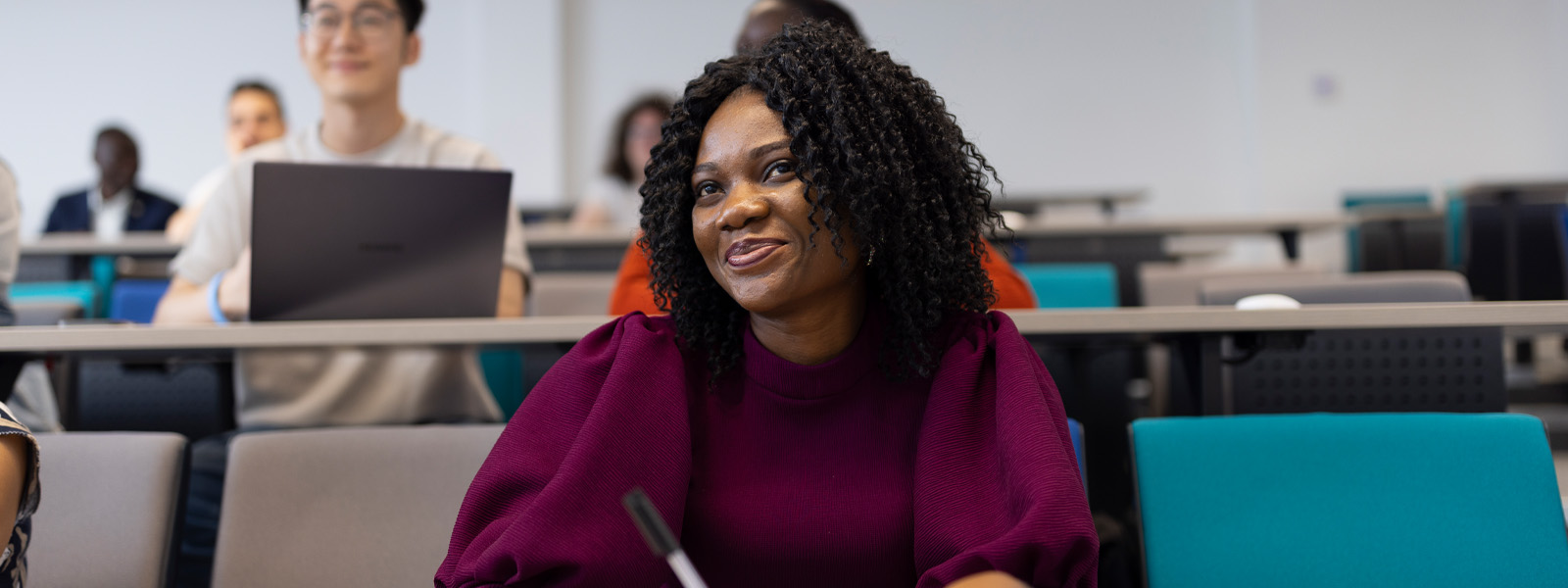 A student sat working in a seminar room