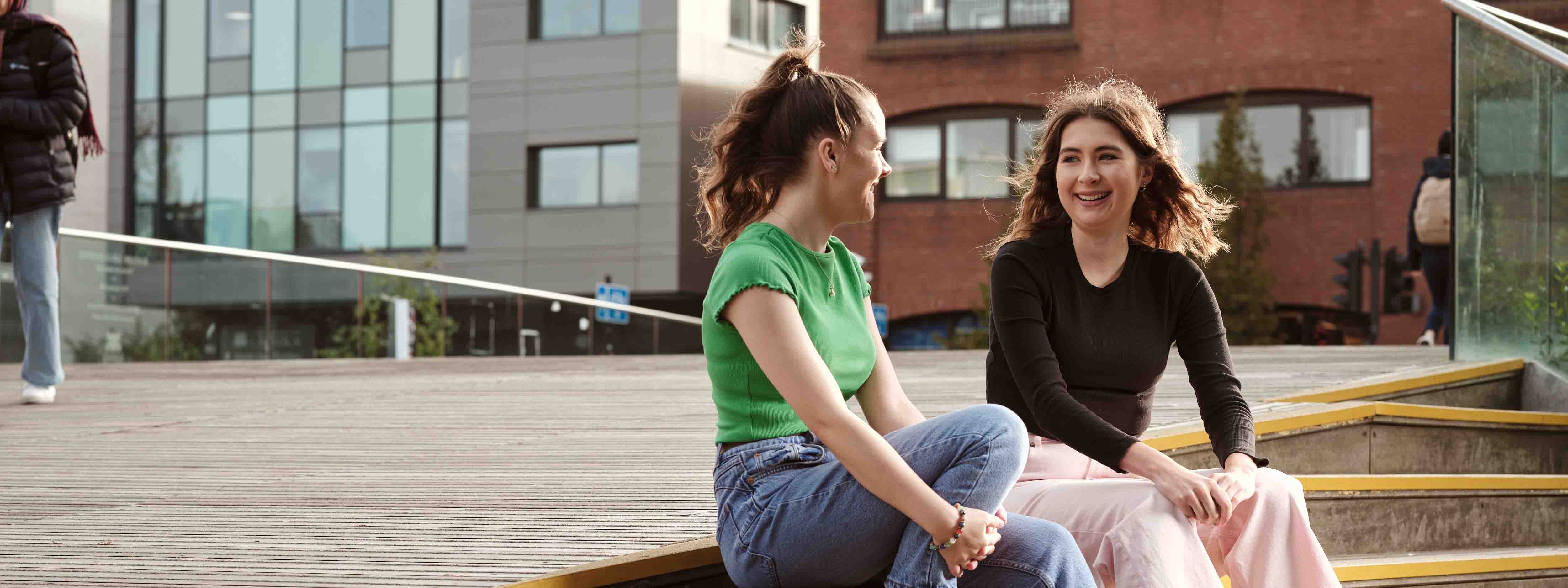 Two students sitting and laughing